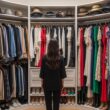 woman choosing outfit in walk-in closet