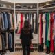 woman choosing outfit in walk-in closet